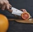 Miyabi Artisan 8" Chef's Knife shown cutting an orange