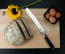 Shun Classic 9 in. (230mm) Bread Knife shown on cutting board with bread