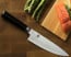Shun Classic 8 in. HG Chef Knife shown with cutting board and vegetables