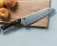 Shun Kanso 7 in. HG Santoku displayed on cutting board