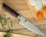 Shun Premier 8 in Chef Knife  shown on cutting board with produce