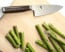 Shun Premier 6 in. (150mm) Chef Knife shown with asparagus