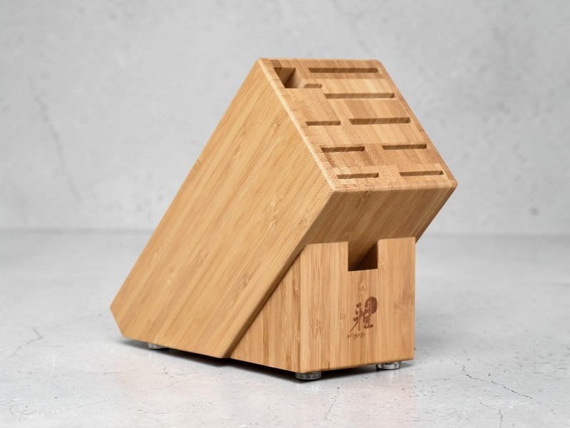 An elegant wooden knife block holding a set of Miyabi knives.